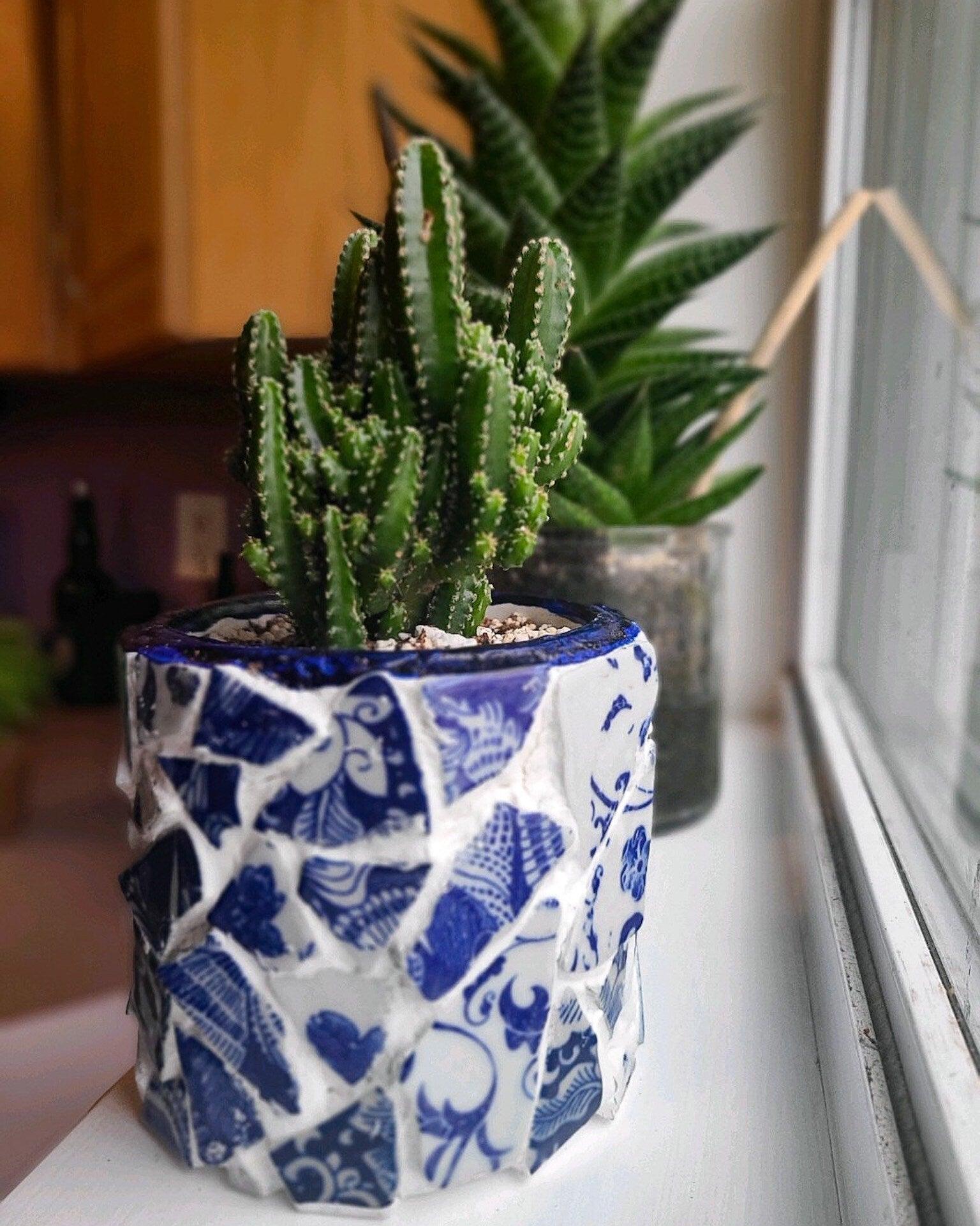 White broken china mosaic planter with intricate design, perfect for indoor or outdoor plant display.