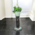 Handcrafted mosaic pedestal planter with colorful tiled design, ideal for displaying indoor or outdoor plants.