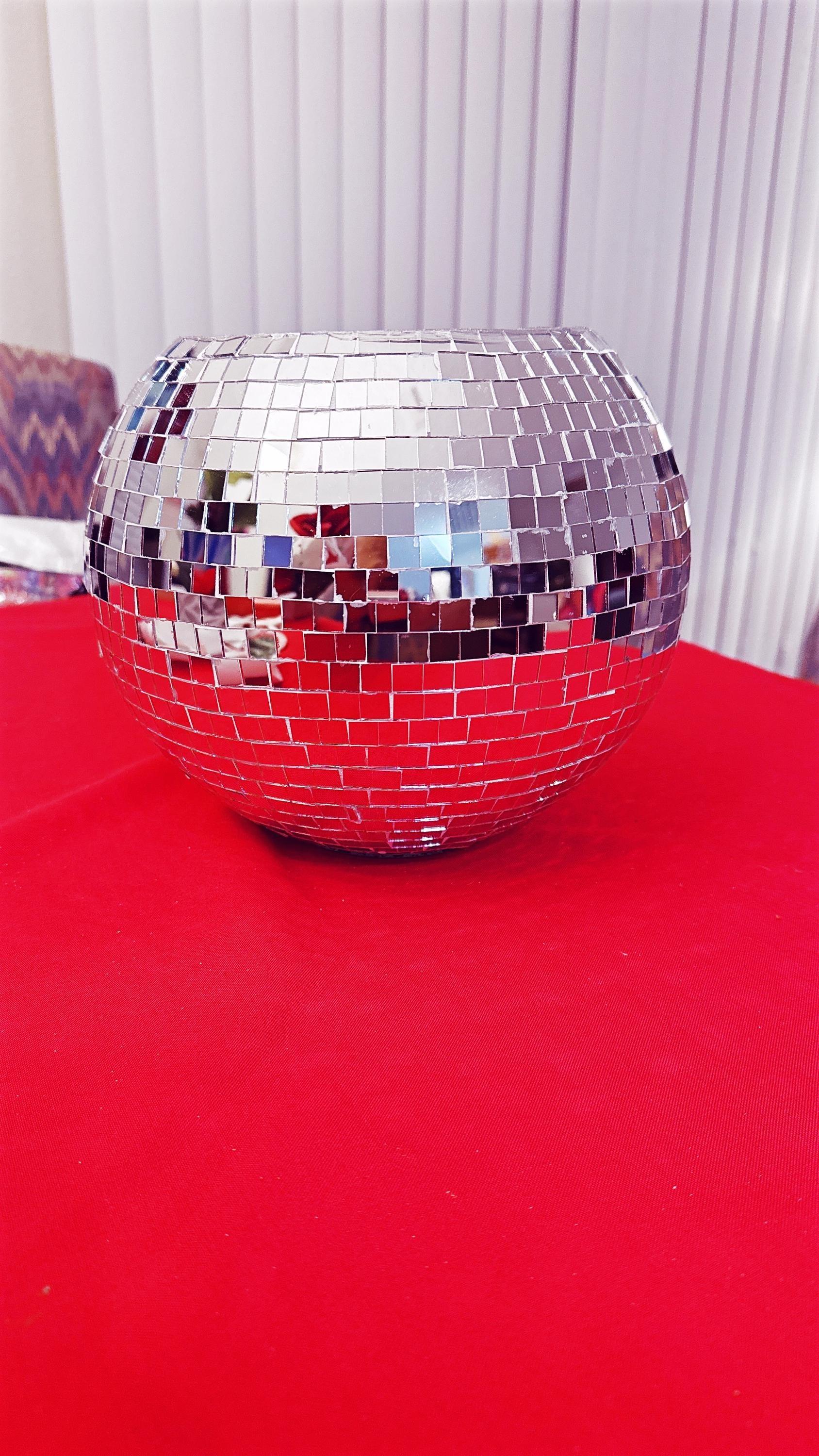 Shimmering mirror ball disco globe vase with reflective surface, perfect for modern home decor or party centerpiece.