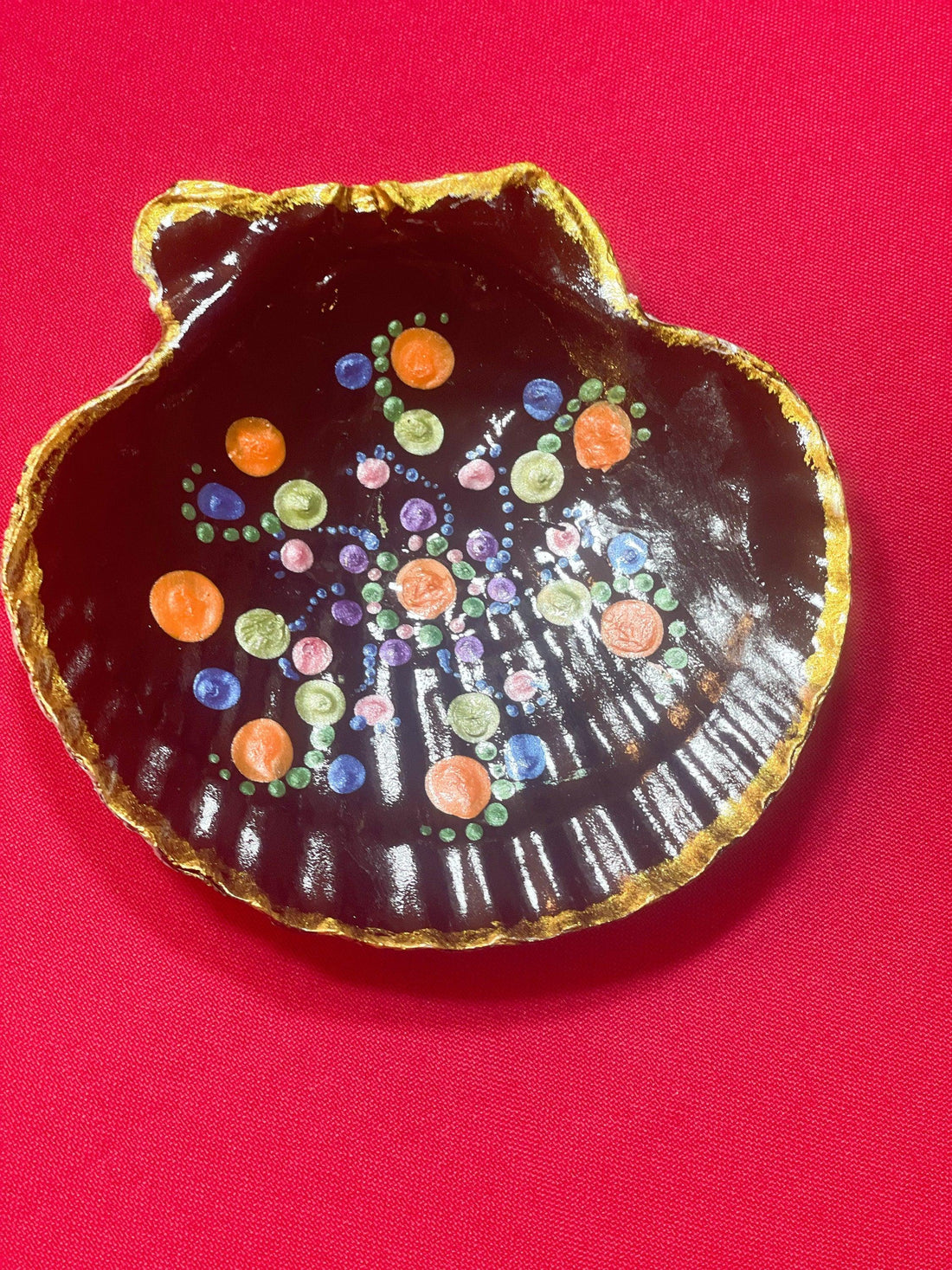 Hand-painted ceramic ring dish with colorful floral design, used for jewelry storage and decoration.