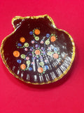 Hand-painted ceramic ring dish with colorful floral design, used for jewelry storage and decoration.