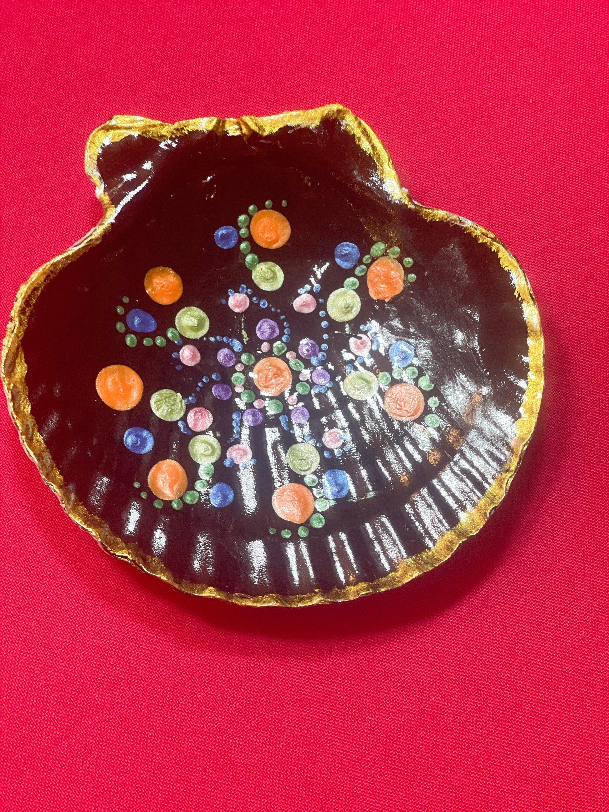 Hand-painted ceramic ring dish with colorful floral design, used for jewelry storage and decoration.