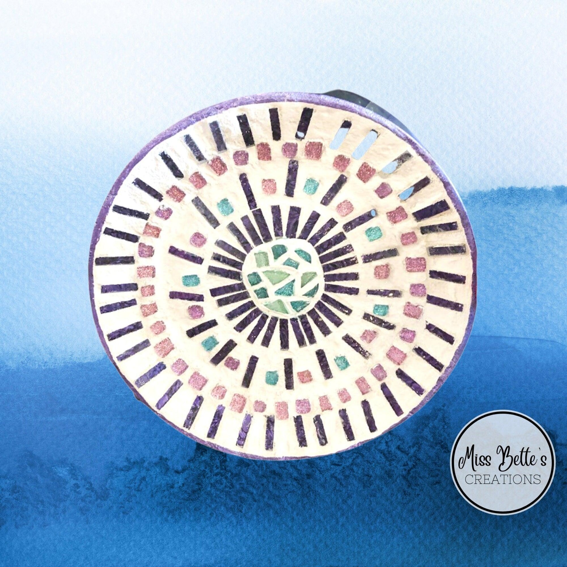 Colorful mosaic butterfly decorative hot plate with intricate design, used as a coaster for protecting surfaces.