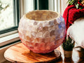 Handcrafted scalloped capiz shell globe vase with a smooth, round shape and intricate shell design.