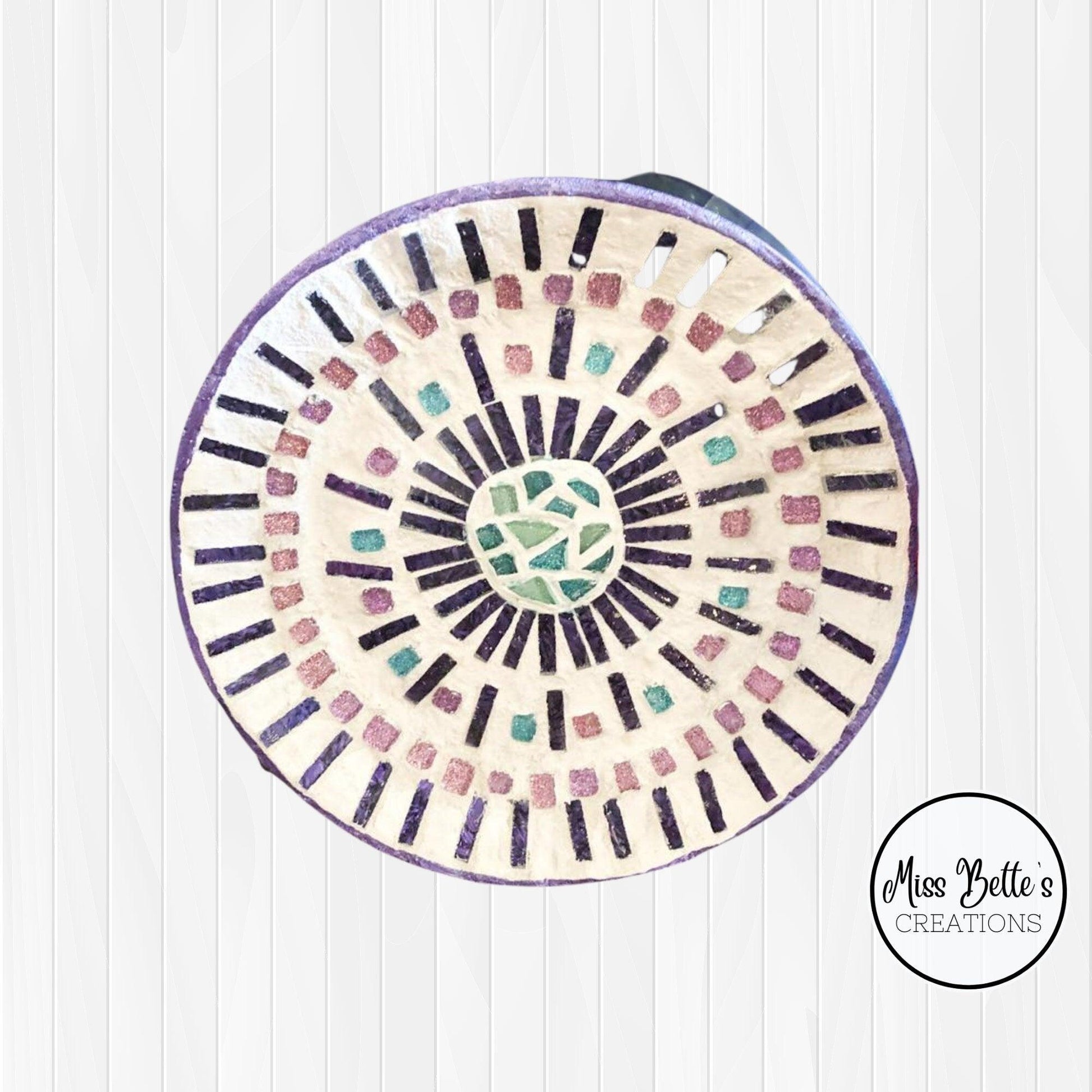 Colorful butterfly decorative hot plate with mosaic design, used as a coaster for protecting surfaces from heat.