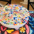 White rainbow mosaic plant stand with handcrafted design, showcasing vibrant mosaic tiles and sturdy white base.