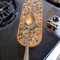 My Store trivet, spoon rest, and plant stand with decorative ceramic design, versatile kitchen and home decor accessory.