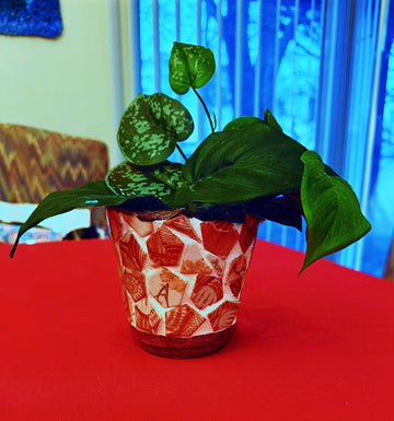 Handcrafted broken china mosaic flower pot featuring colorful, intricate floral design for decorative garden or indoor use.