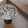 Round handmade mosaic side table with colorful tiled surface and wooden legs, ideal for living room or bedroom decor.