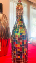 Stained glass look wine decanter featuring colorful stained glass design, elegant glass body, and tapered neck for pouring.