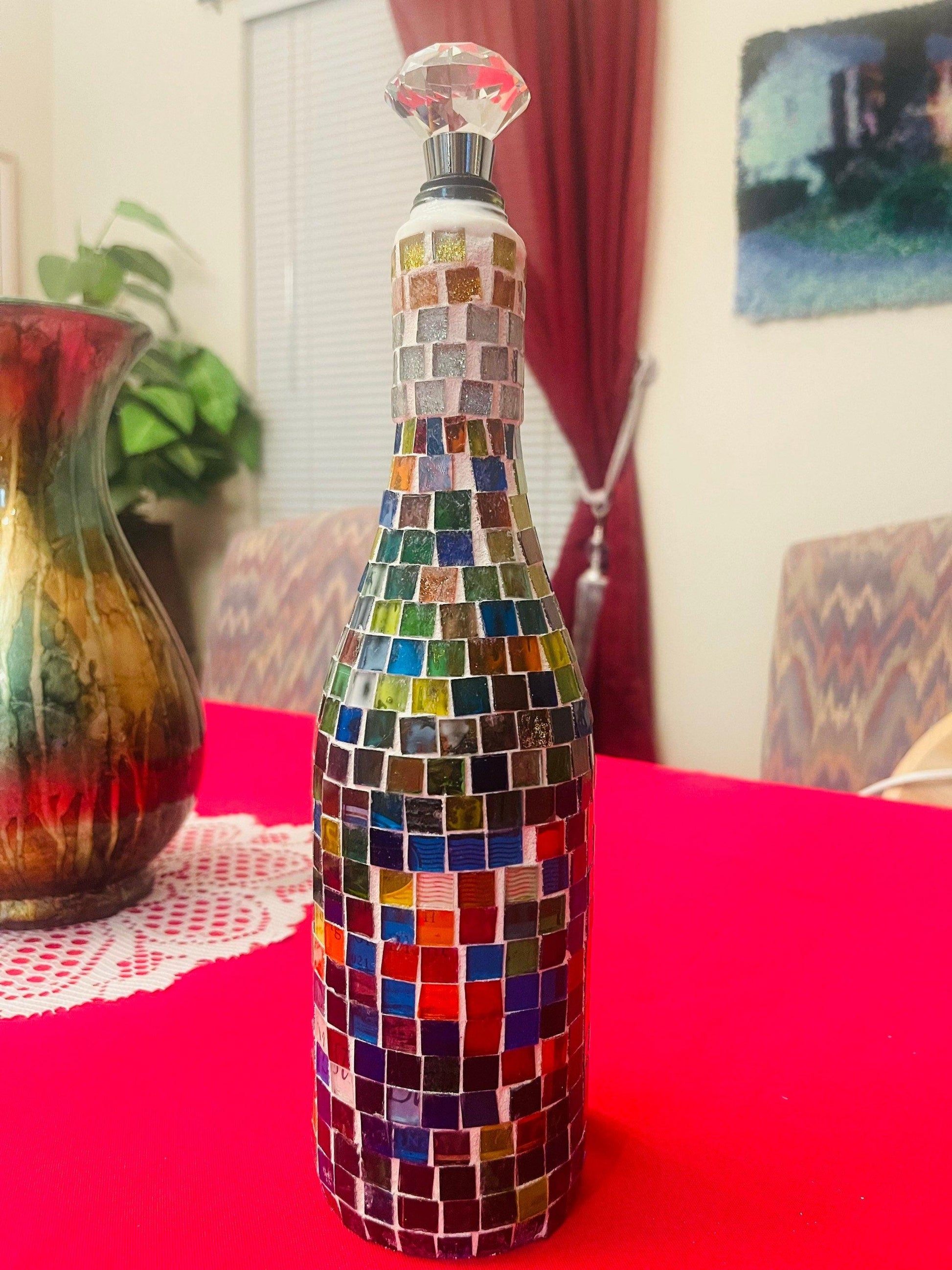 Stained glass look wine decanter with intricate colorful design, elegant glass vessel for wine serving and decanting.