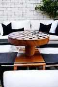 Handmade black and white checkered mosaic plant stand with a round top and decorative base, ideal for indoor or outdoor plants.