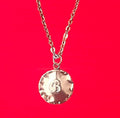 Vintage initial charm necklace featuring a gold chain and personalized letter charm, perfect for everyday wear.