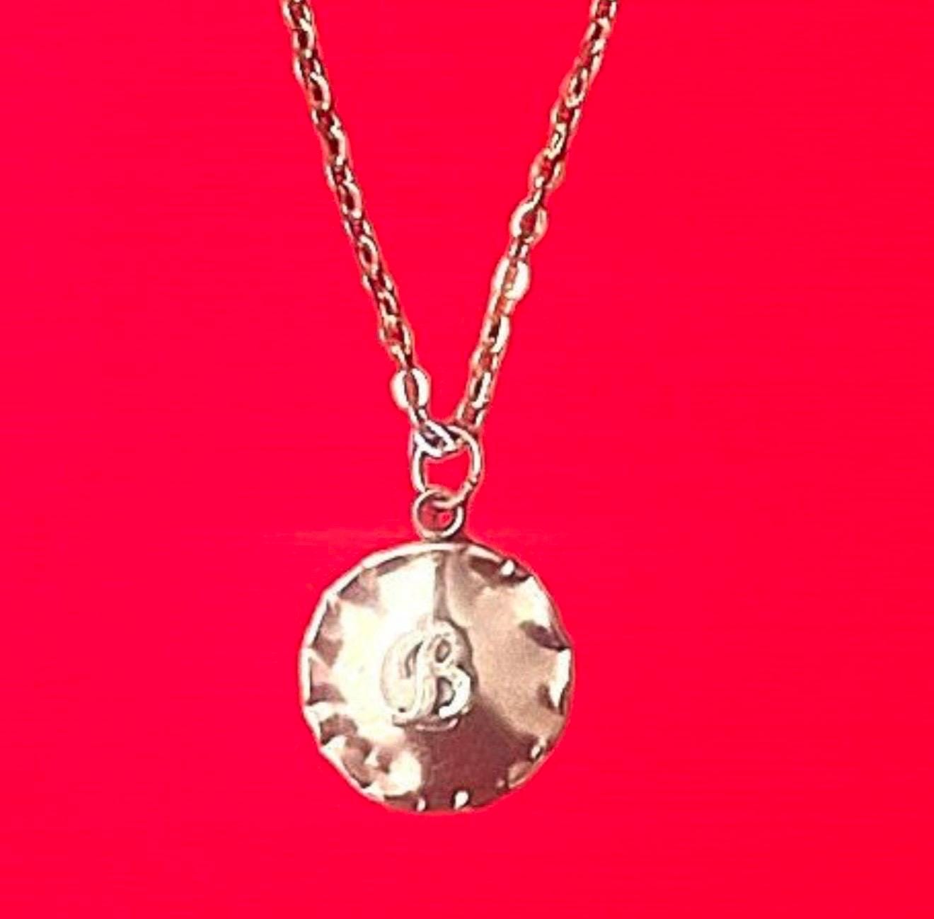 Vintage initial charm necklace featuring a gold chain and personalized letter charm, perfect for everyday wear.