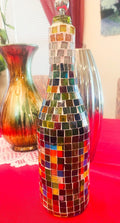 Stained glass look wine decanter with intricate colorful designs, elegant glass body, and a wide opening for pouring wine.