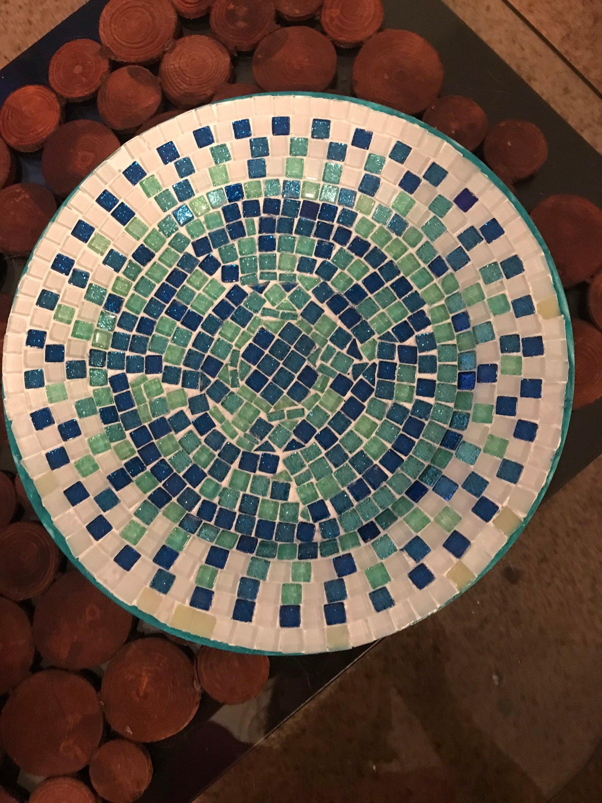 Iridescent turquoise mosaic glass wall art with shimmering geometric patterns, perfect for modern interior decor.