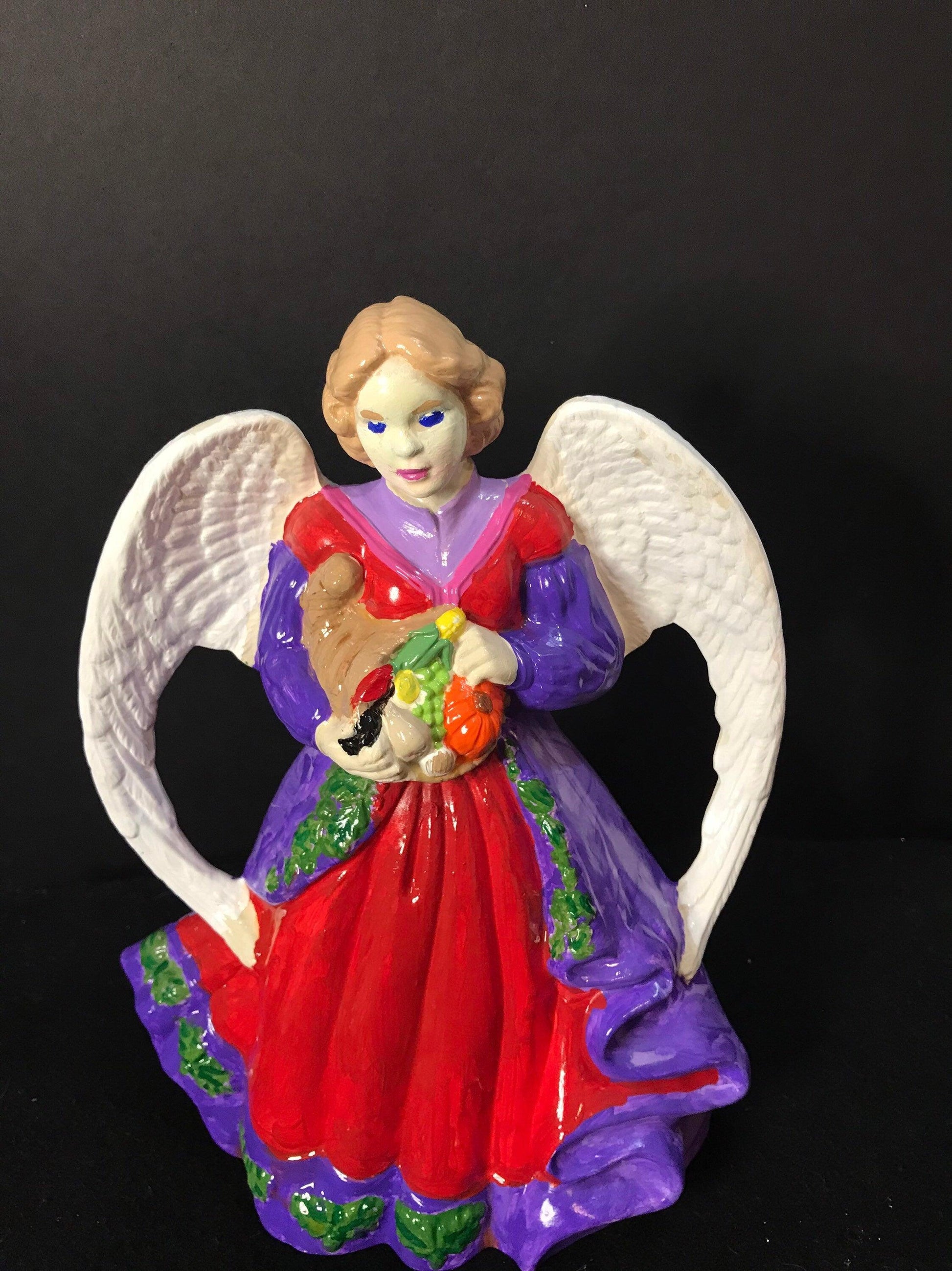 Hand-painted Harvest Angel figurine with detailed wings and autumn-themed attire, perfect for seasonal decor.