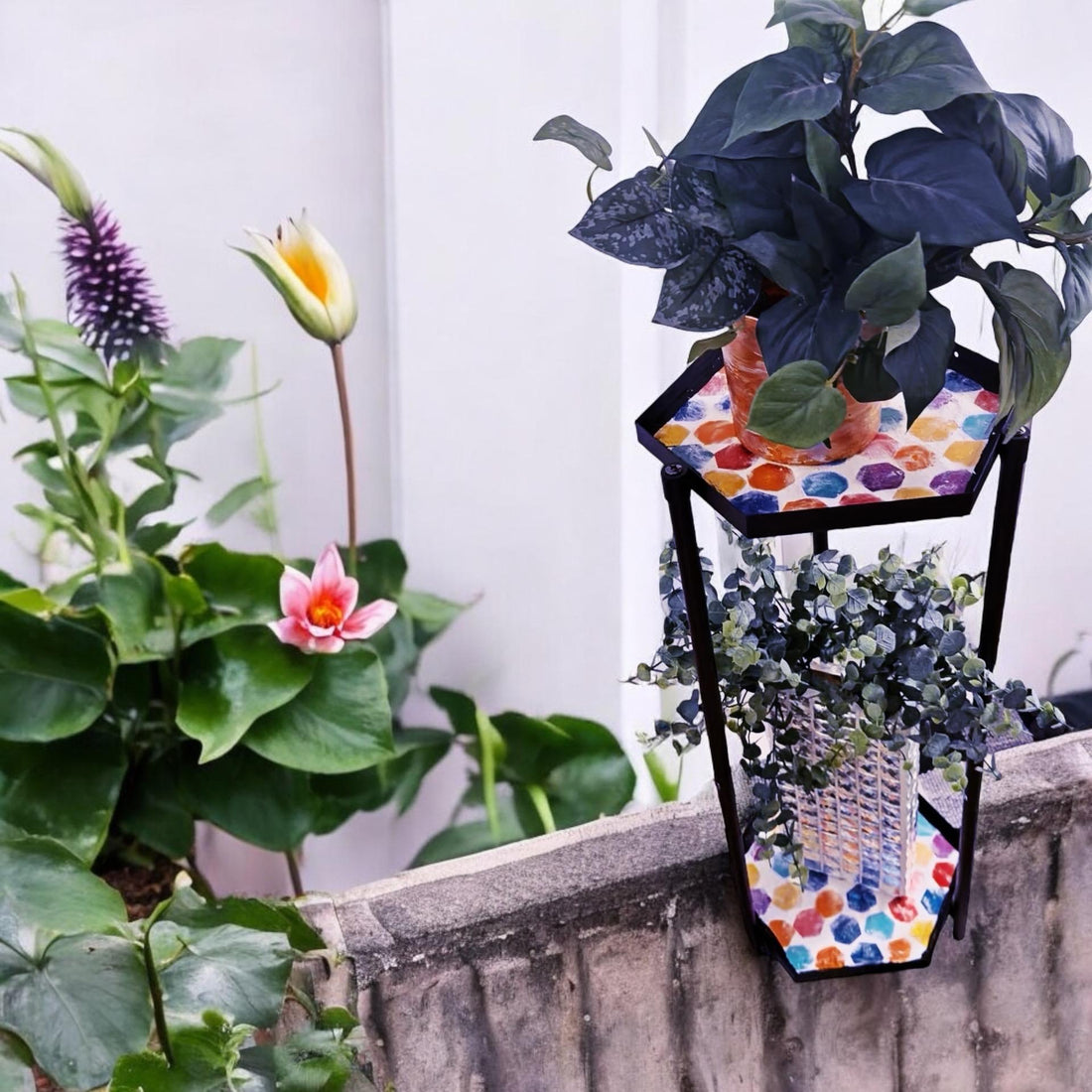 Handcrafted 2-tier rainbow mosaic plant stand with colorful tiled shelves, perfect for displaying potted plants.