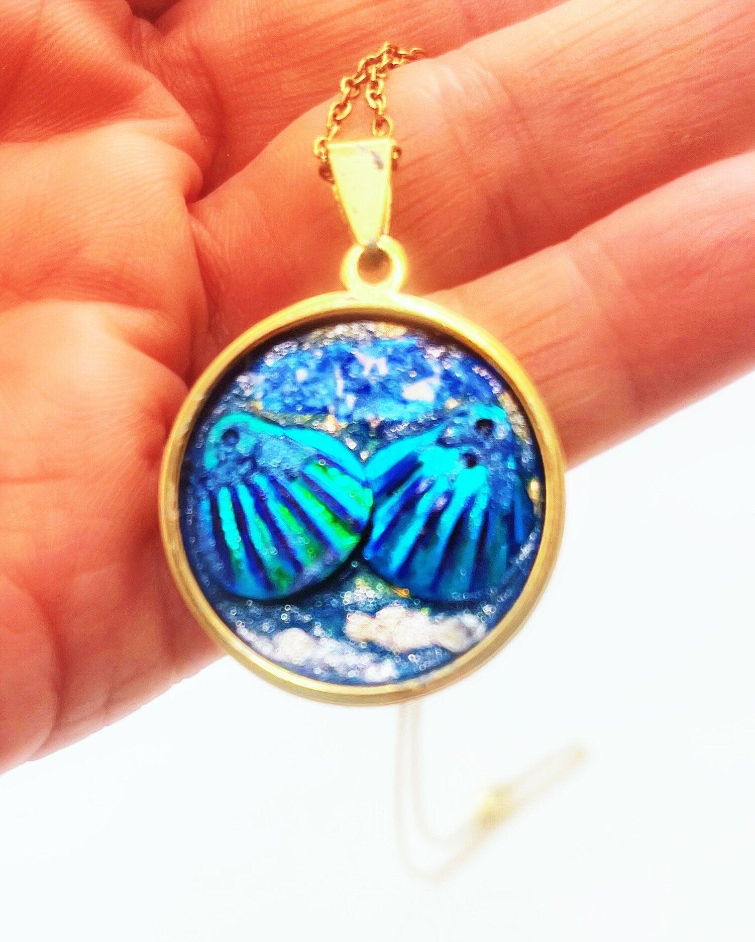 Ocean blue shell medallion necklace featuring a large shell pendant on a silver chain, stylish jewelry accessory.