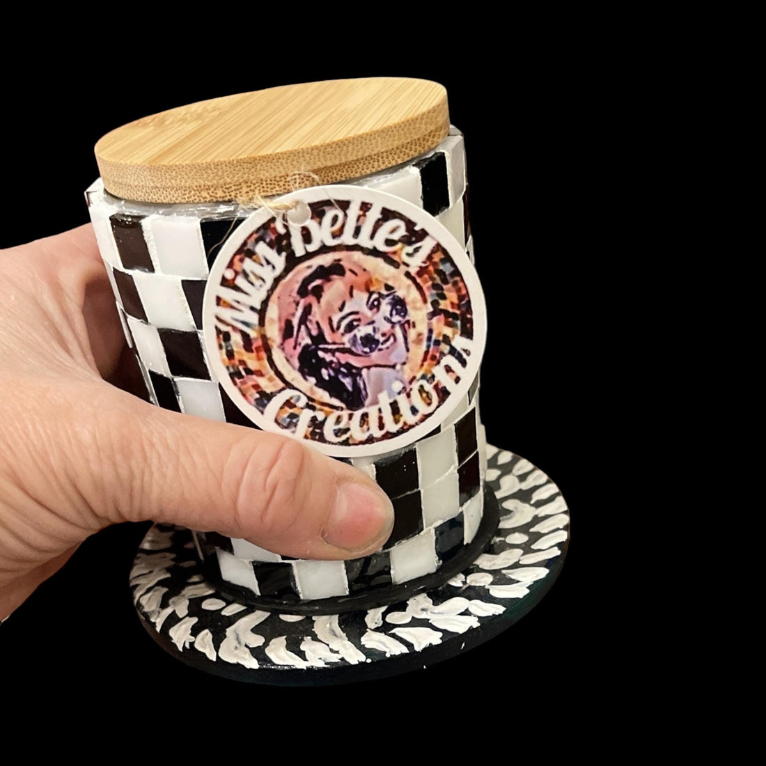 Handcrafted black and white checkerboard mosaic jar with intricate pattern, showcasing artistic craftsmanship and decorative design.