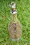 Luxury gold mosaic wine decanter with intricate design and elegant shape, perfect for showcasing wine in a stylish way.