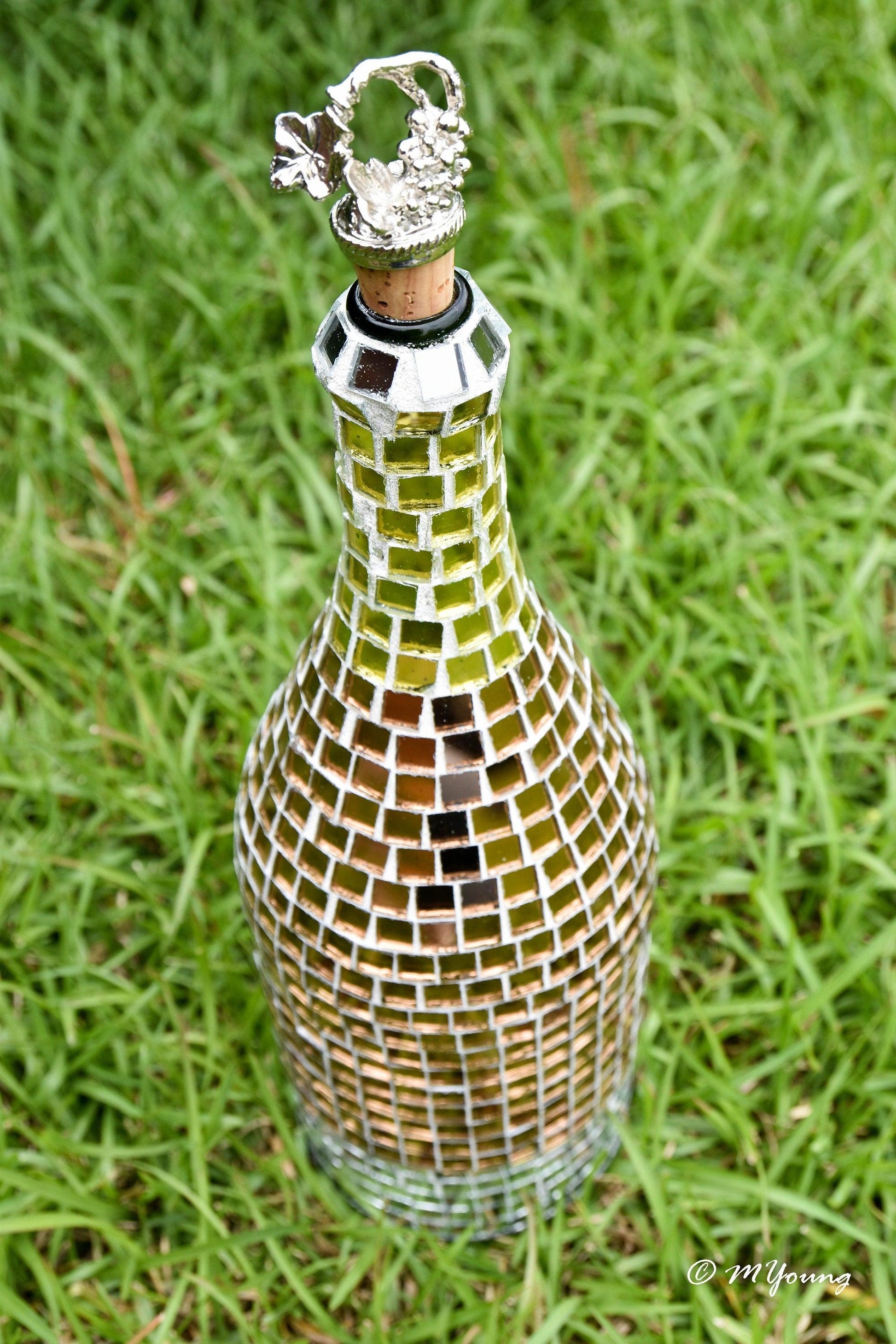 Luxury gold mosaic wine decanter with intricate design and elegant shape, perfect for showcasing wine in a stylish way.