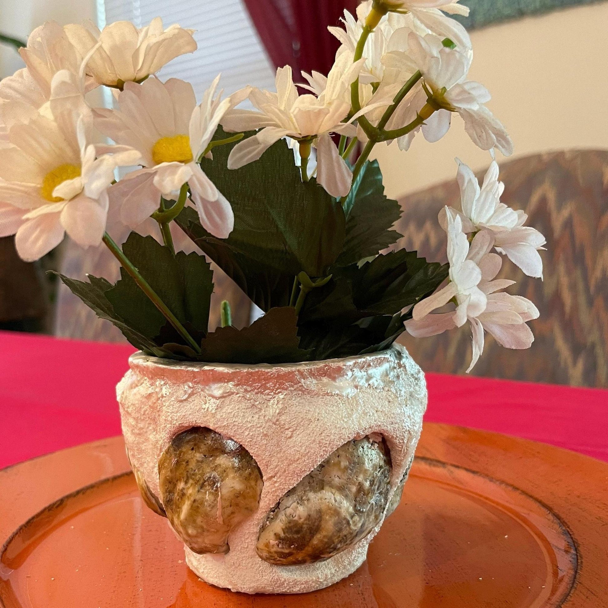 Handcrafted seashell and sandstone mini planter with natural textures, perfect for small indoor plants or decorative displays