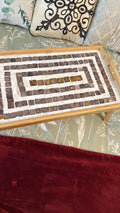 Rustic bamboo bed tray with stone mosaic inlay, showcasing a natural wooden surface with decorative mosaic details.