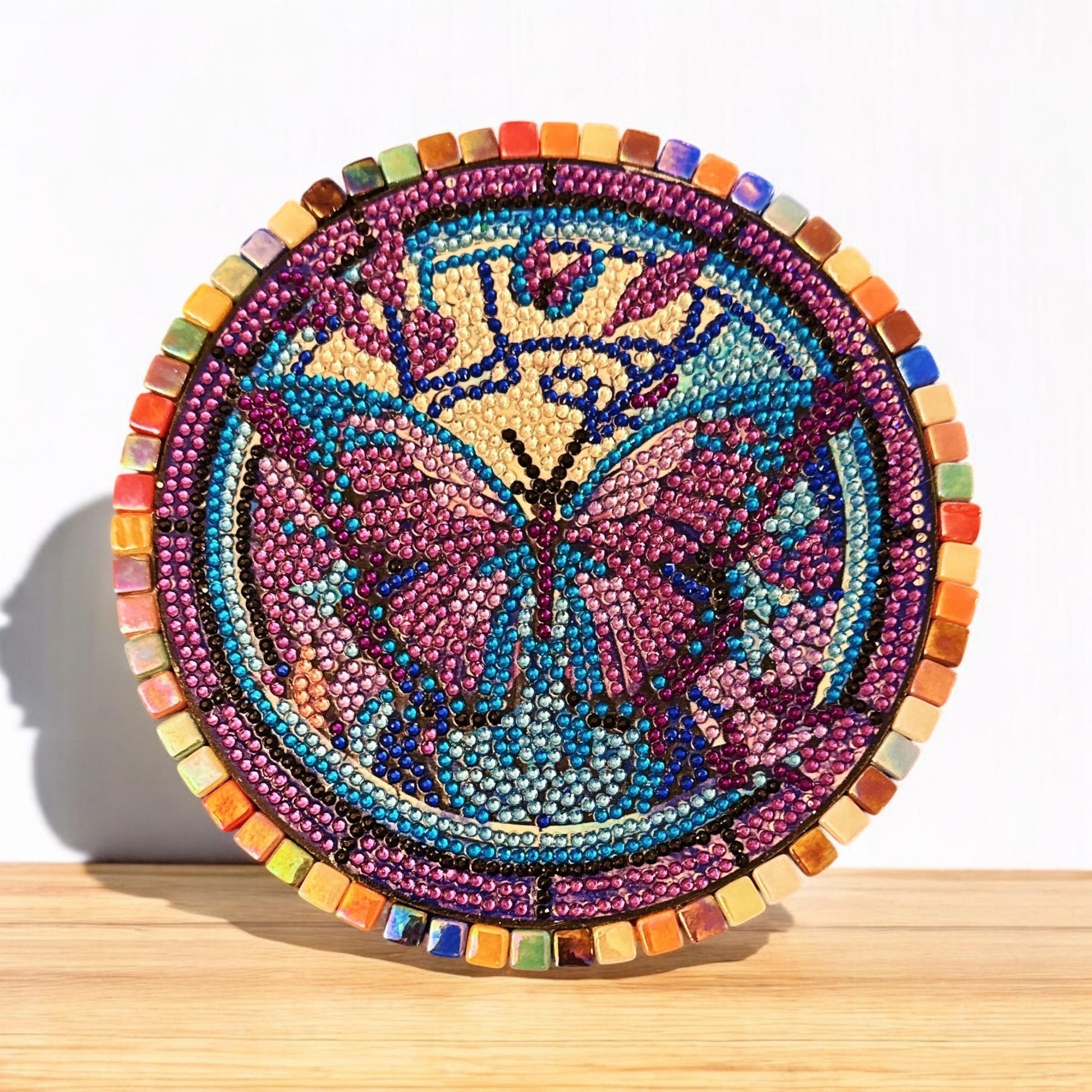 Butterfly crystal mosaic trivet and decorative display with colorful glass tiles and intricate design for kitchen decor.